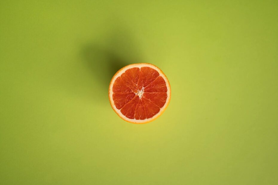 slice of grapefruit on green surface